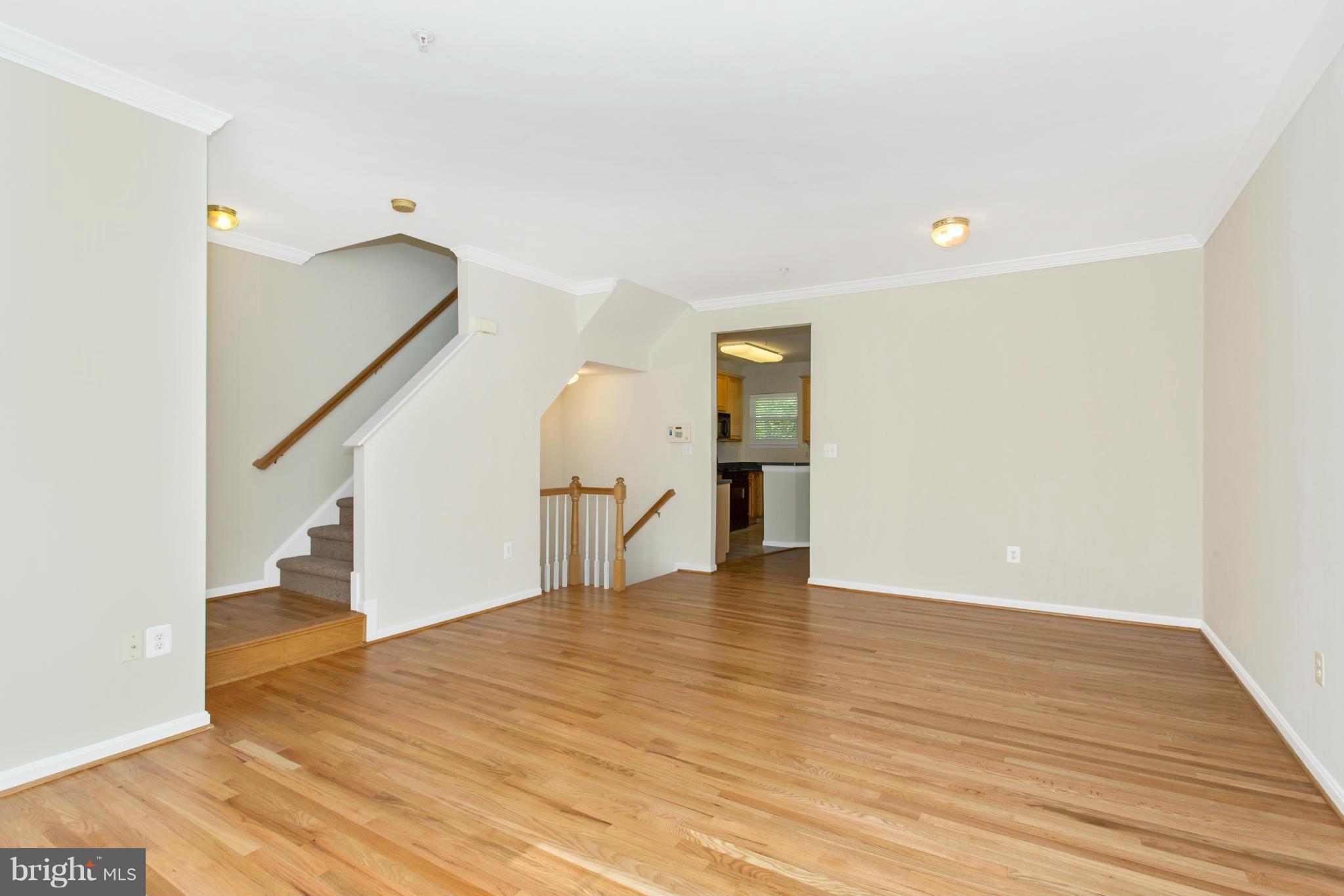 11006 Hemingway Court Silver Spring, MD 20902 - Photo 9 of 30 a view of an empty room with wooden floor and stairs