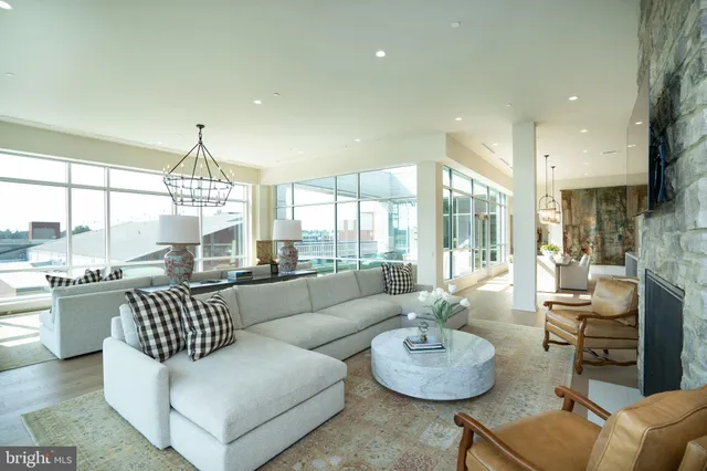 a living room with furniture and a chandelier