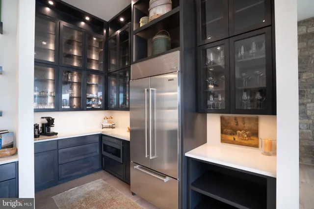 a kitchen with stainless steel appliances granite countertop a refrigerator and a stove