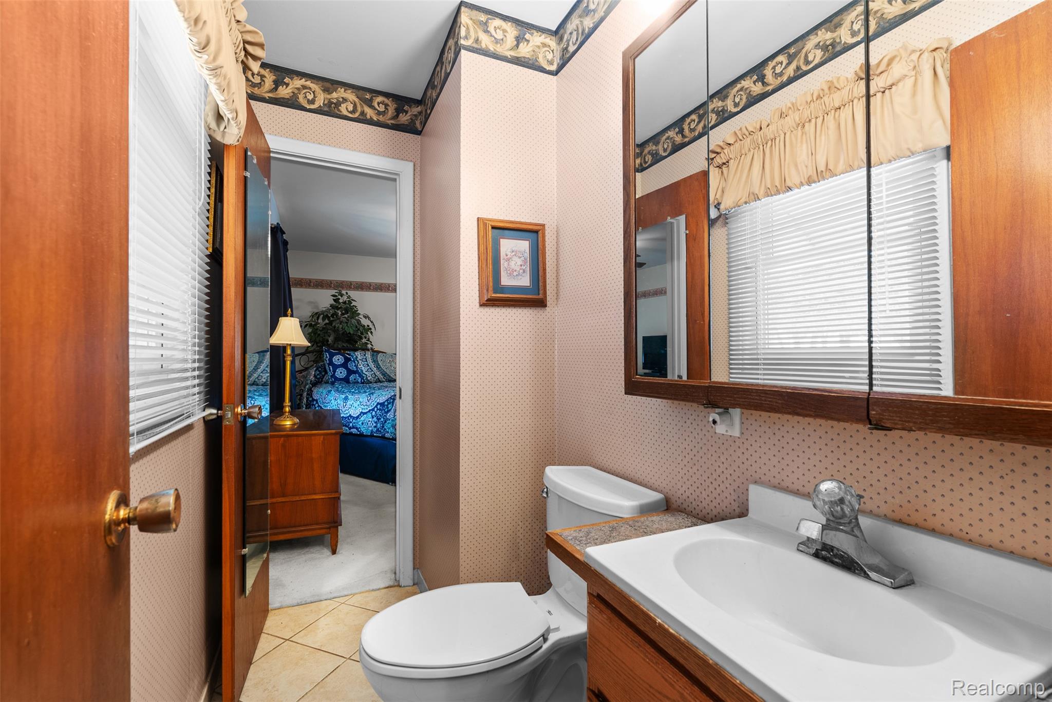 7192 Torrey Road Swartz Creek, MI 48473 - Photo 11 of 27 Ensuite bathroom featuring wallpapered walls, vanity, and light tile patterned floors