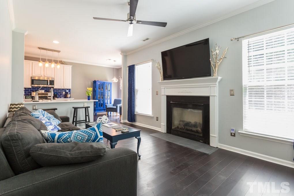 8419 Tie Stone Way Raleigh, NC 27613 - Photo 2 of 30 a living room with fireplace furniture and a flat screen tv