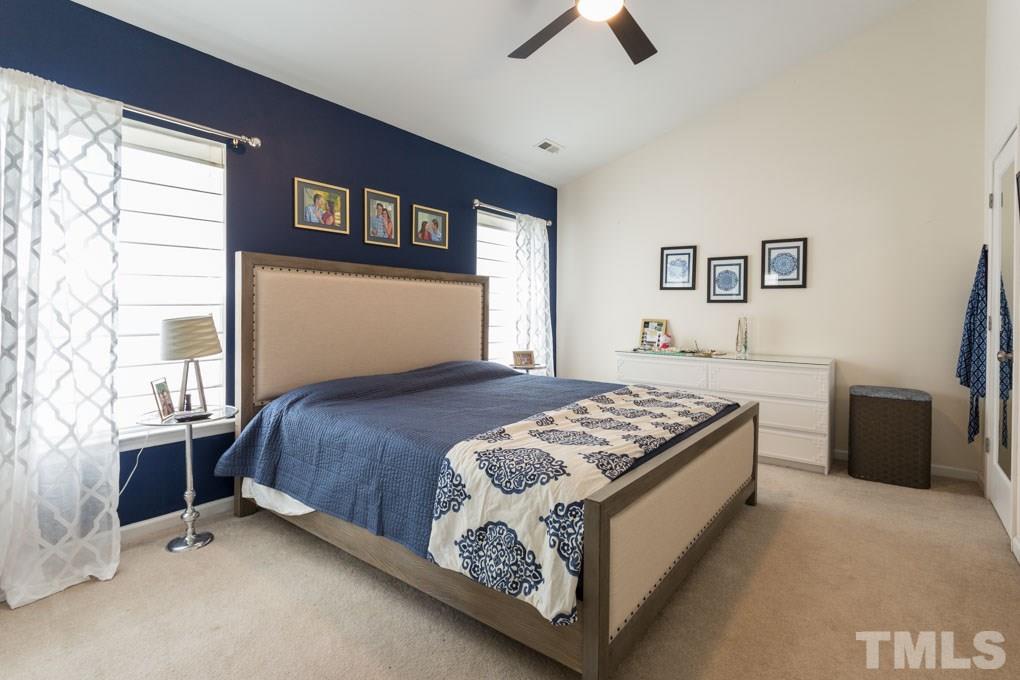 8419 Tie Stone Way Raleigh, NC 27613 - Photo 17 of 30 a bedroom with a bed and a couch