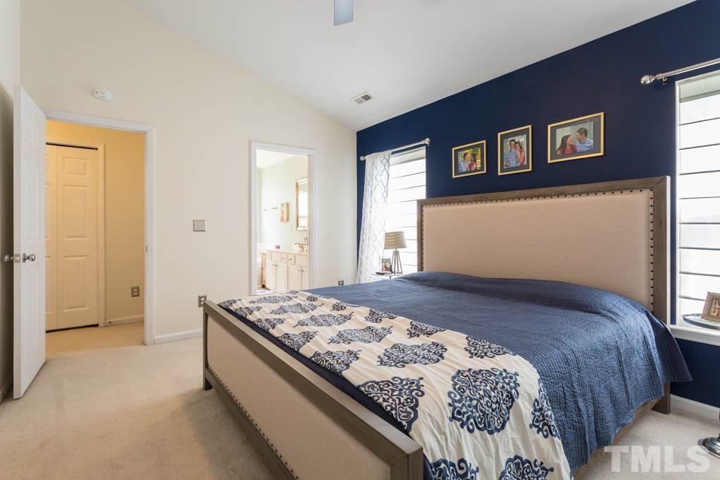 8419 Tie Stone Way Raleigh, NC 27613 - Photo 18 of 30 a bedroom with a bed and a window