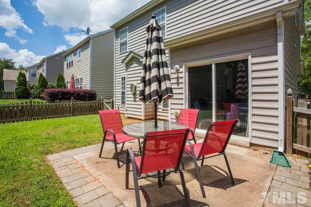 8419 Tie Stone Way Raleigh, NC 27613 - Photo 25 of 30 a patio with table and chairs and potted plants
