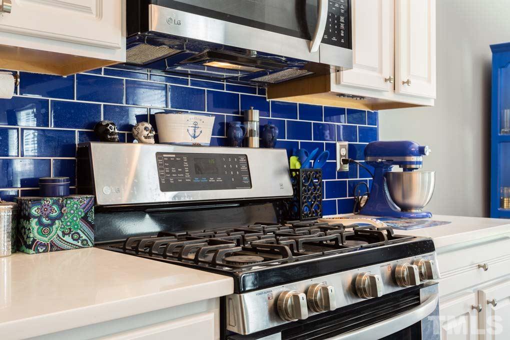 8419 Tie Stone Way Raleigh, NC 27613 - Photo 9 of 30 a stove top oven sitting inside of a kitchen