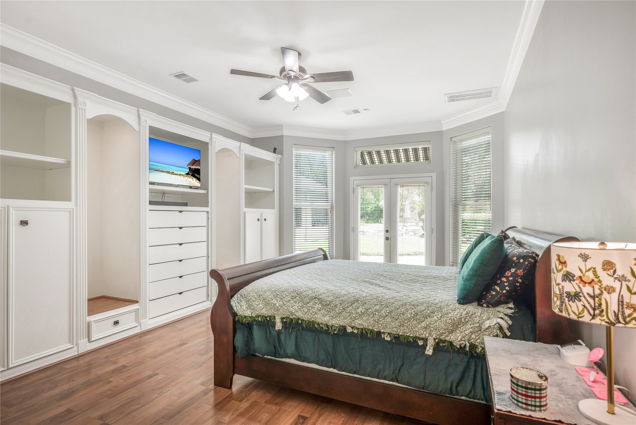13914 Skinner Road Cypress, TX 77429 - Photo 15 of 50 Primary bedroom with hardwood floors, a tray ceiling, ceiling fan, and large windows overlooking the backyard.
