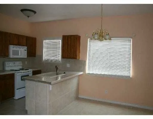 a kitchen with a sink cabinets and window