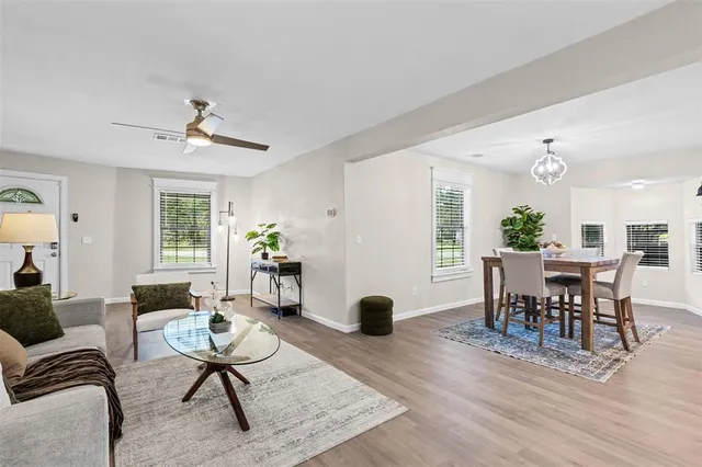 a living room with furniture a rug and a window