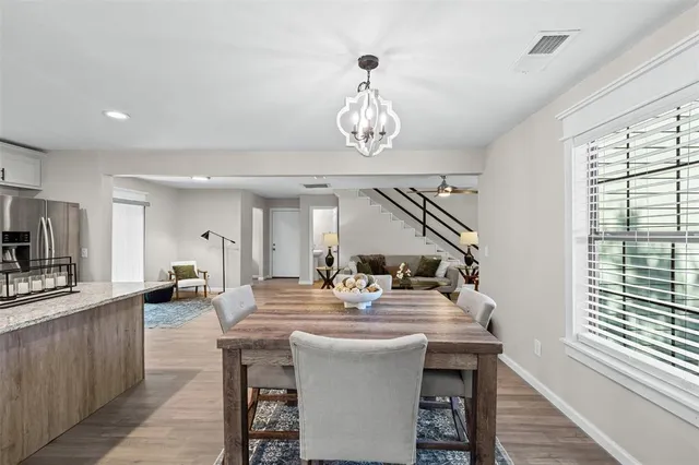 a very nice looking dining room with a large dining table and chairs