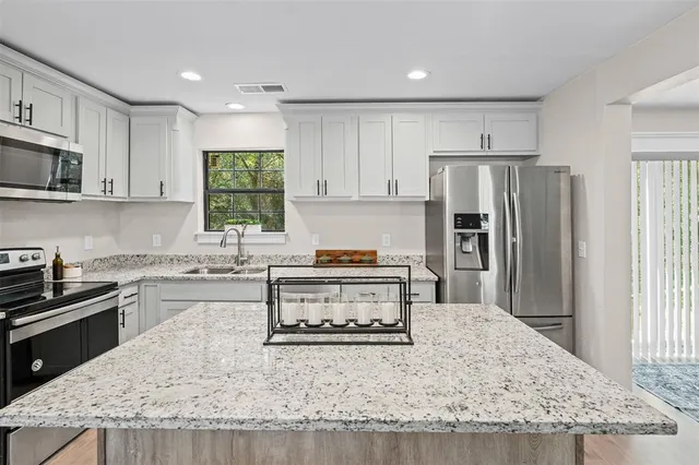 a kitchen with a stove a sink and a refrigerator