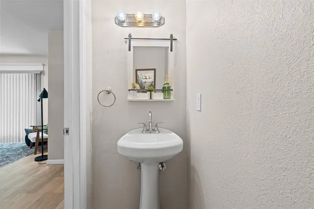 a bathroom with a sink a mirror and a shower