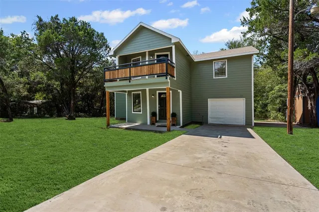 a front view of house with a garden