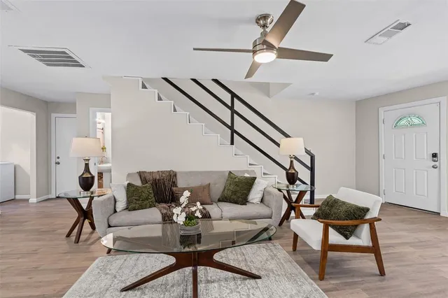 a living room with furniture and wooden floor