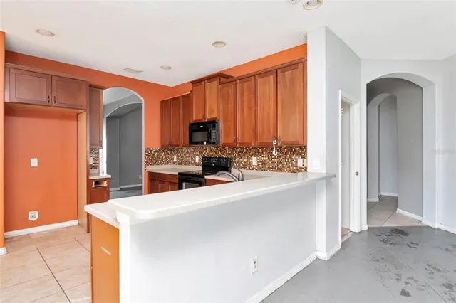 a kitchen with stainless steel appliances a sink cabinets and wooden floor