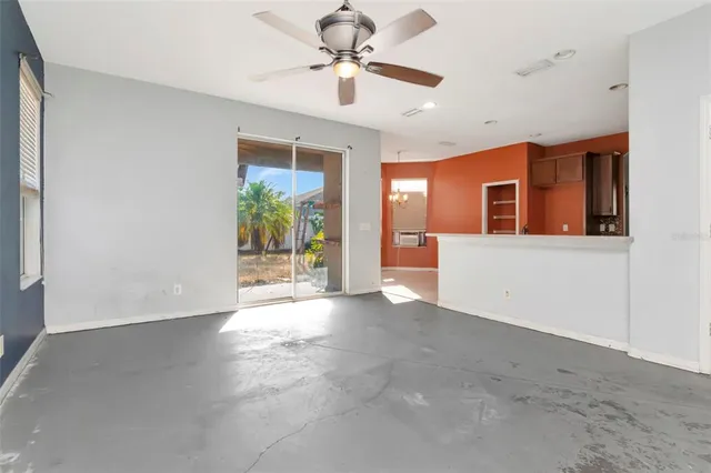 a view of a livingroom with a ceiling fan and window