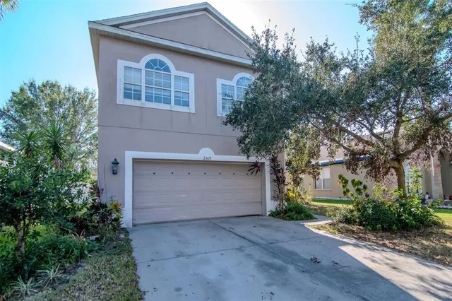 a front view of house with yard and trees