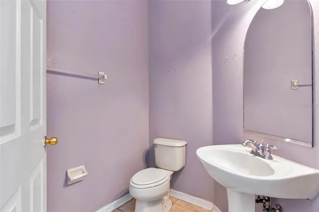 a bathroom with a sink a toilet and mirror