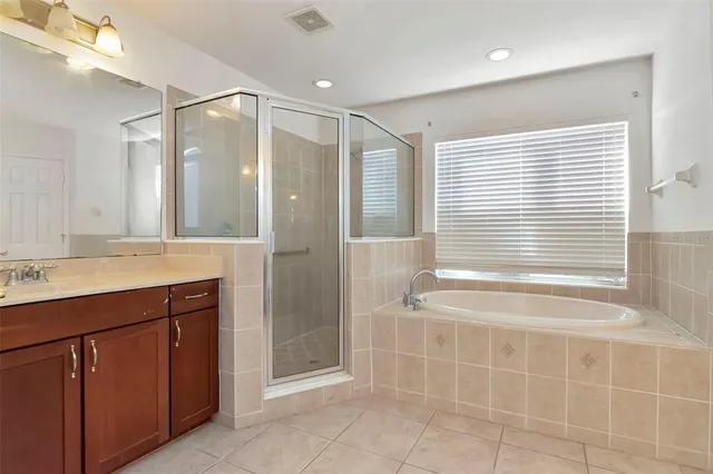 a bathroom with a bathtub a sink and a shower