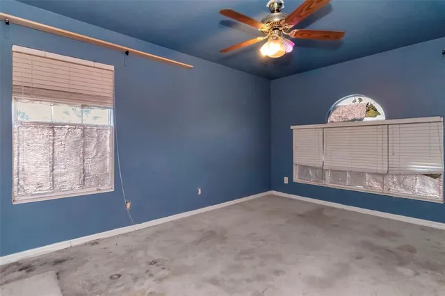 a view of a livingroom with a ceiling fan and window