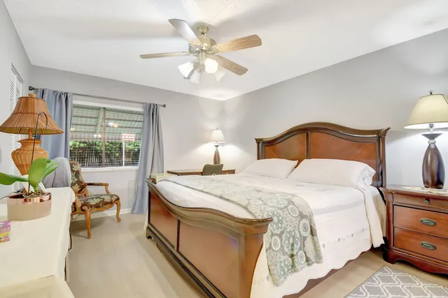 a bedroom with bed and a chandelier