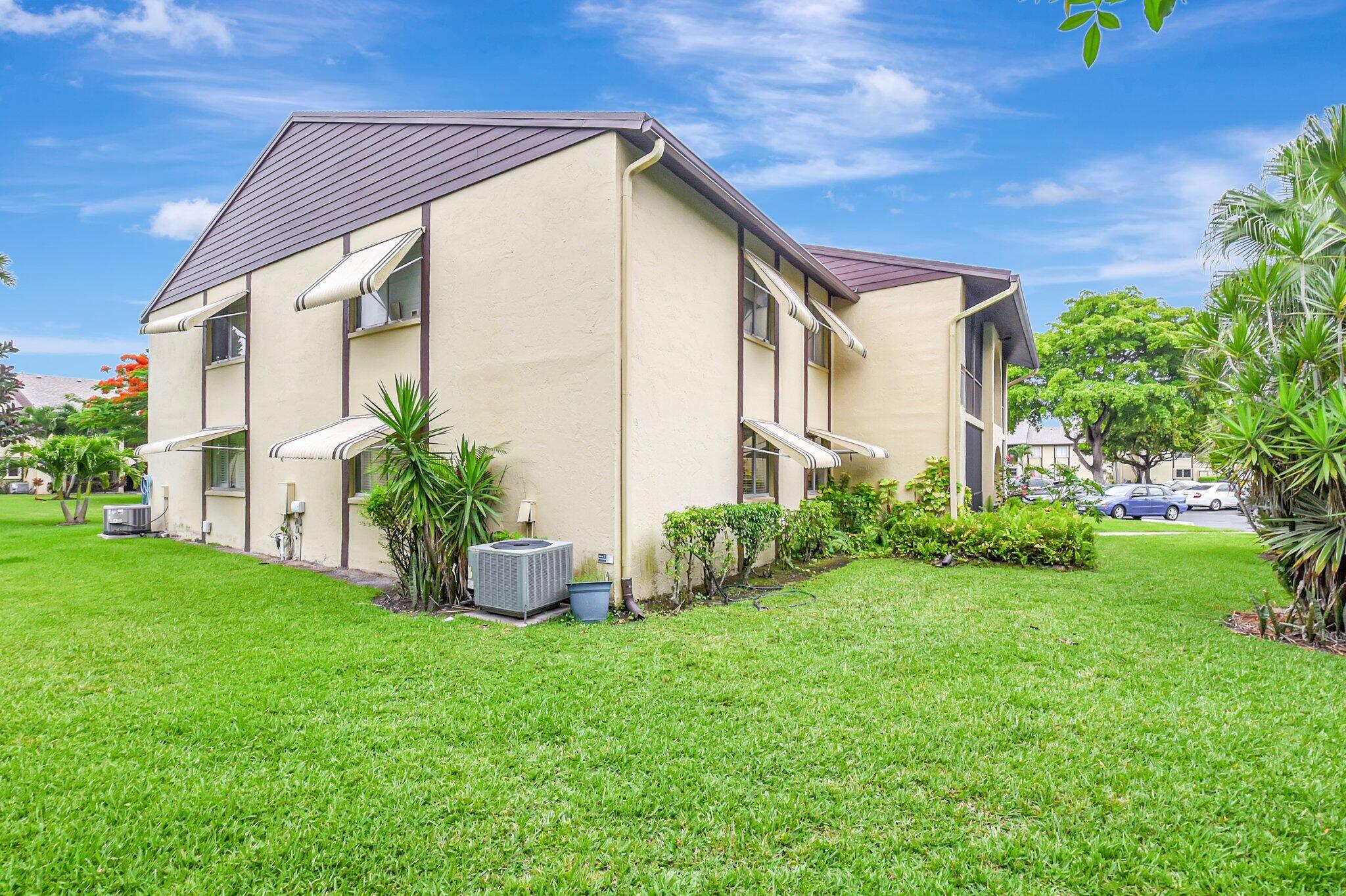 323 Pine Ridge Circle, Unit A1 Greenacres, FL 33463 - Photo 31 of 40 a front view of a house with garden