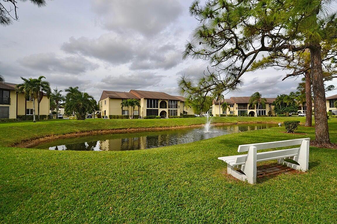 323 Pine Ridge Circle, Unit A1 Greenacres, FL 33463 - Photo 36 of 40 a view of house with a garden