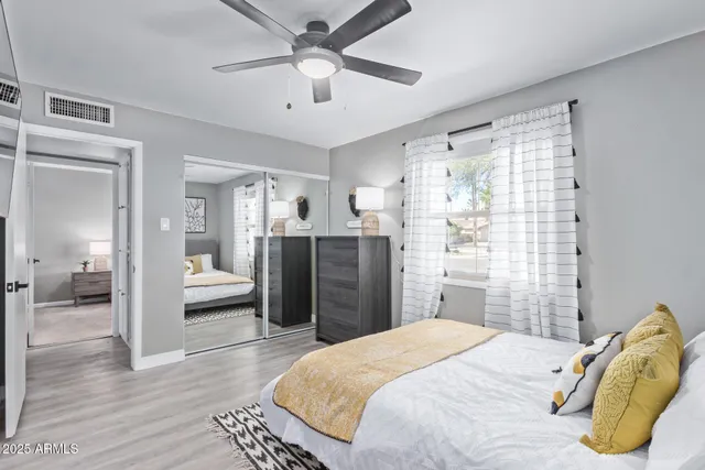 a bedroom with a bed and a chandelier