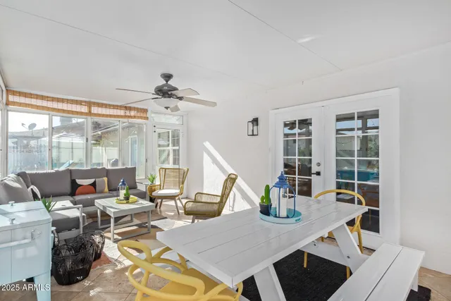 a view of a dining room with furniture large windows and wooden floor