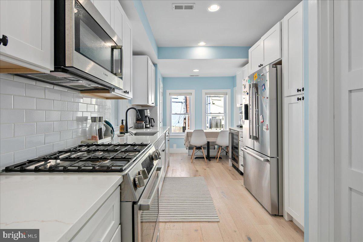 1618 G Street Southeast Washington, DC 20003 - Photo 15 of 53 a kitchen with a stove and a refrigerator