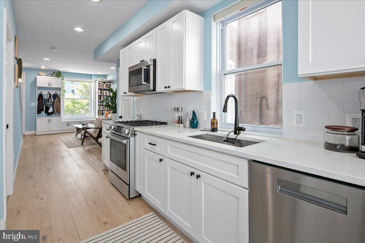 1618 G Street Southeast Washington, DC 20003 - Photo 21 of 53 a kitchen with a sink cabinets stainless steel appliances and a window