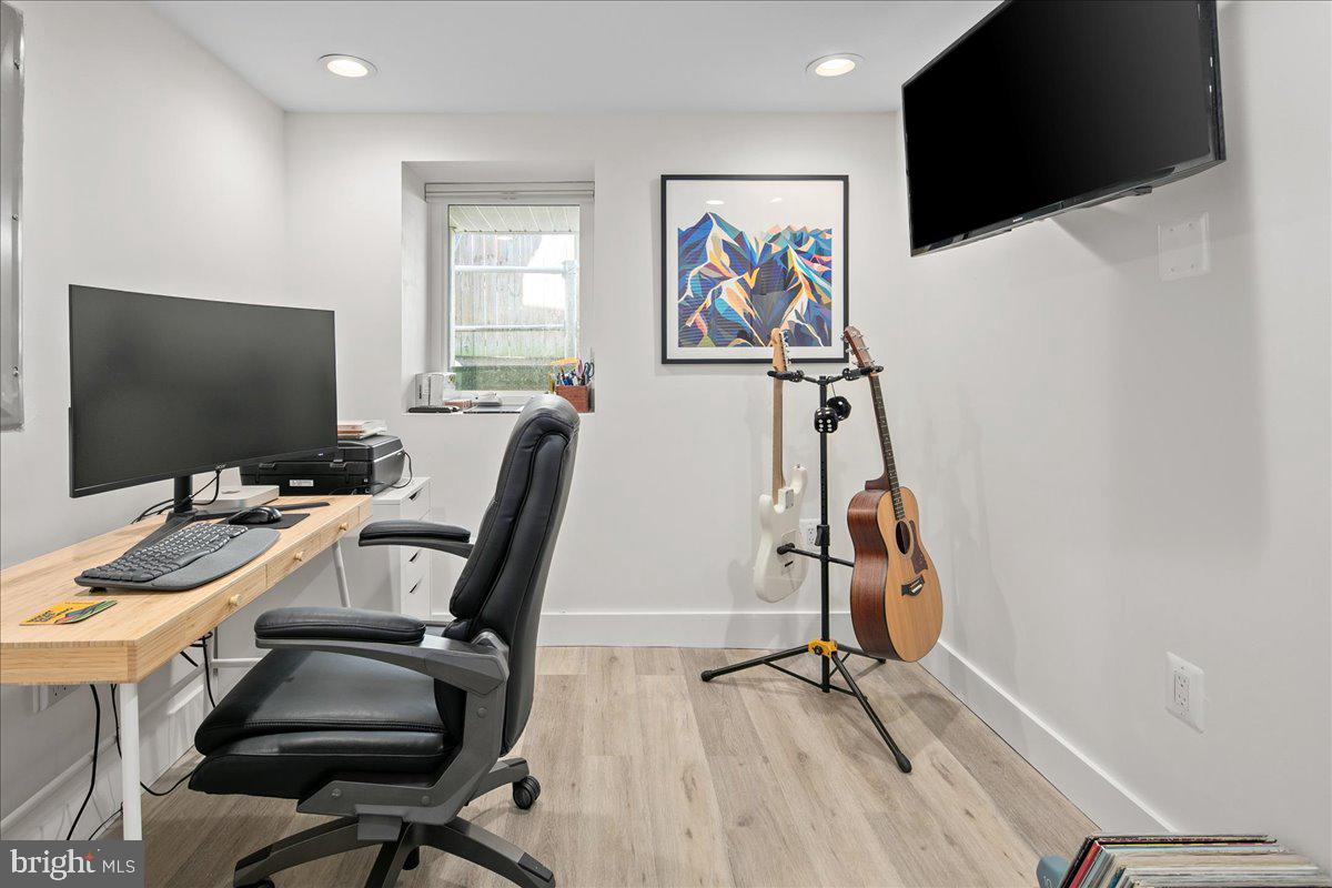 1618 G Street Southeast Washington, DC 20003 - Photo 25 of 53 a view of a workspace with furniture and a flat screen tv