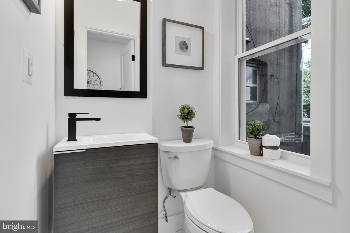 1618 G Street Southeast Washington, DC 20003 - Photo 27 of 53 a bathroom with a toilet a sink and mirror