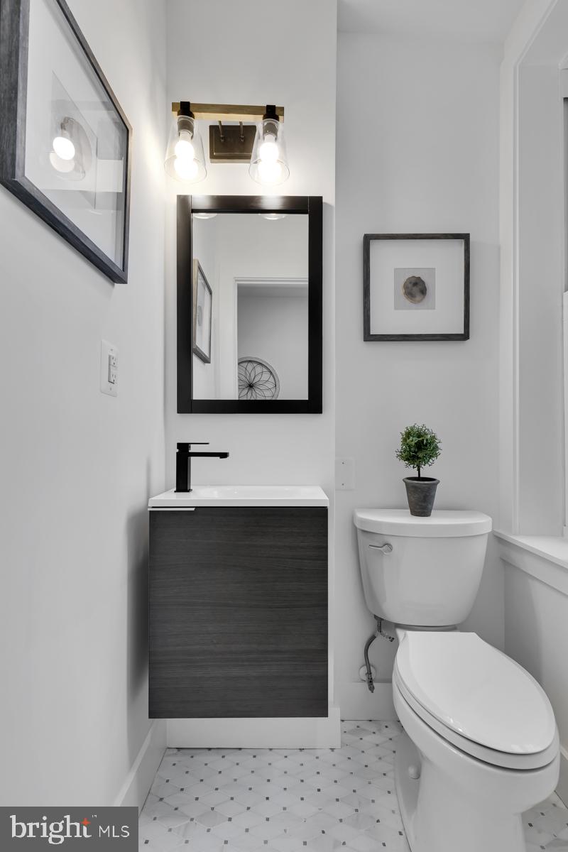 1618 G Street Southeast Washington, DC 20003 - Photo 28 of 53 a bathroom with a toilet a sink and mirror