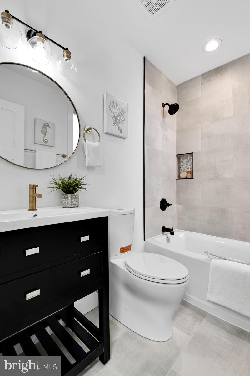 1618 G Street Southeast Washington, DC 20003 - Photo 34 of 53 a bathroom with a toilet a sink and a mirror