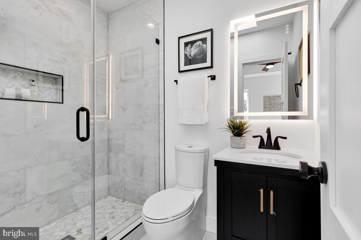 1618 G Street Southeast Washington, DC 20003 - Photo 38 of 53 a bathroom with a granite countertop sink toilet and shower