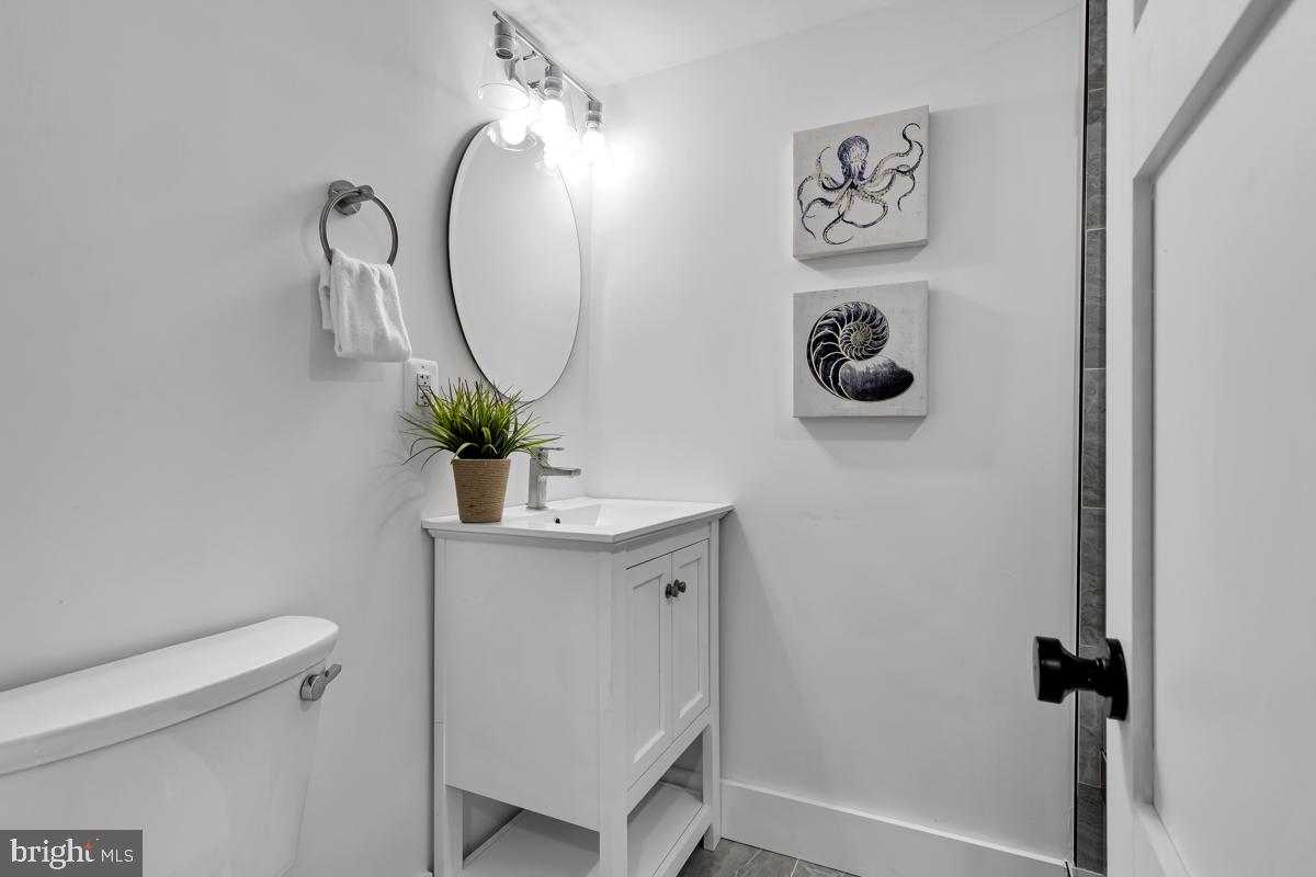 1618 G Street Southeast Washington, DC 20003 - Photo 41 of 53 a bathroom with a sink a mirror and a toilet