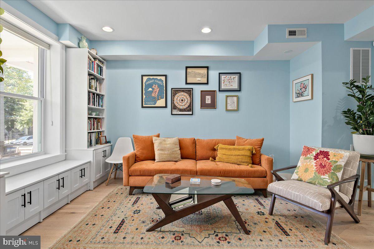 1618 G Street Southeast Washington, DC 20003 - Photo 9 of 53 a blue couch sitting in a living room with a couch