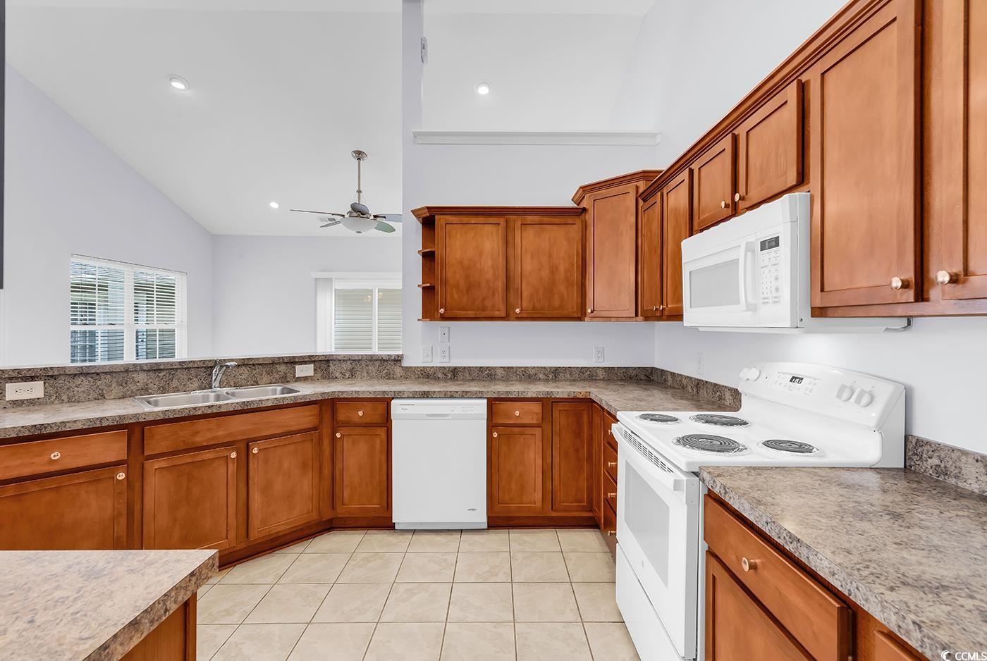 1636 Stuart Square Circle Myrtle Beach, SC 29577 - Photo 13 of 28 Kitchen featuring white appliances, brown cabinets, ceiling fan, light tile patterned flooring, and recessed lighting