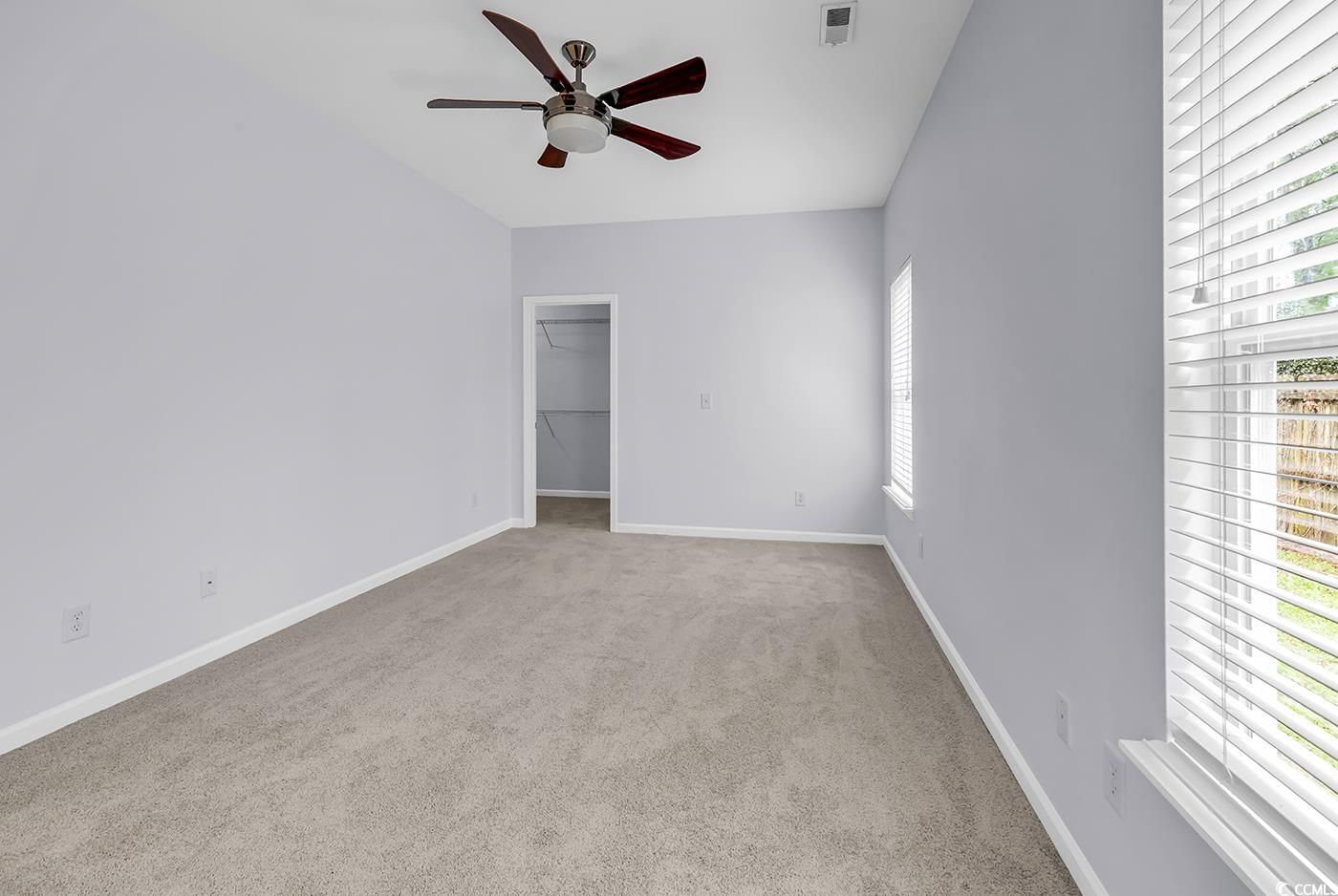 1636 Stuart Square Circle Myrtle Beach, SC 29577 - Photo 17 of 28 Unfurnished room with healthy amount of natural light, ceiling fan, carpet flooring, and lofted ceiling