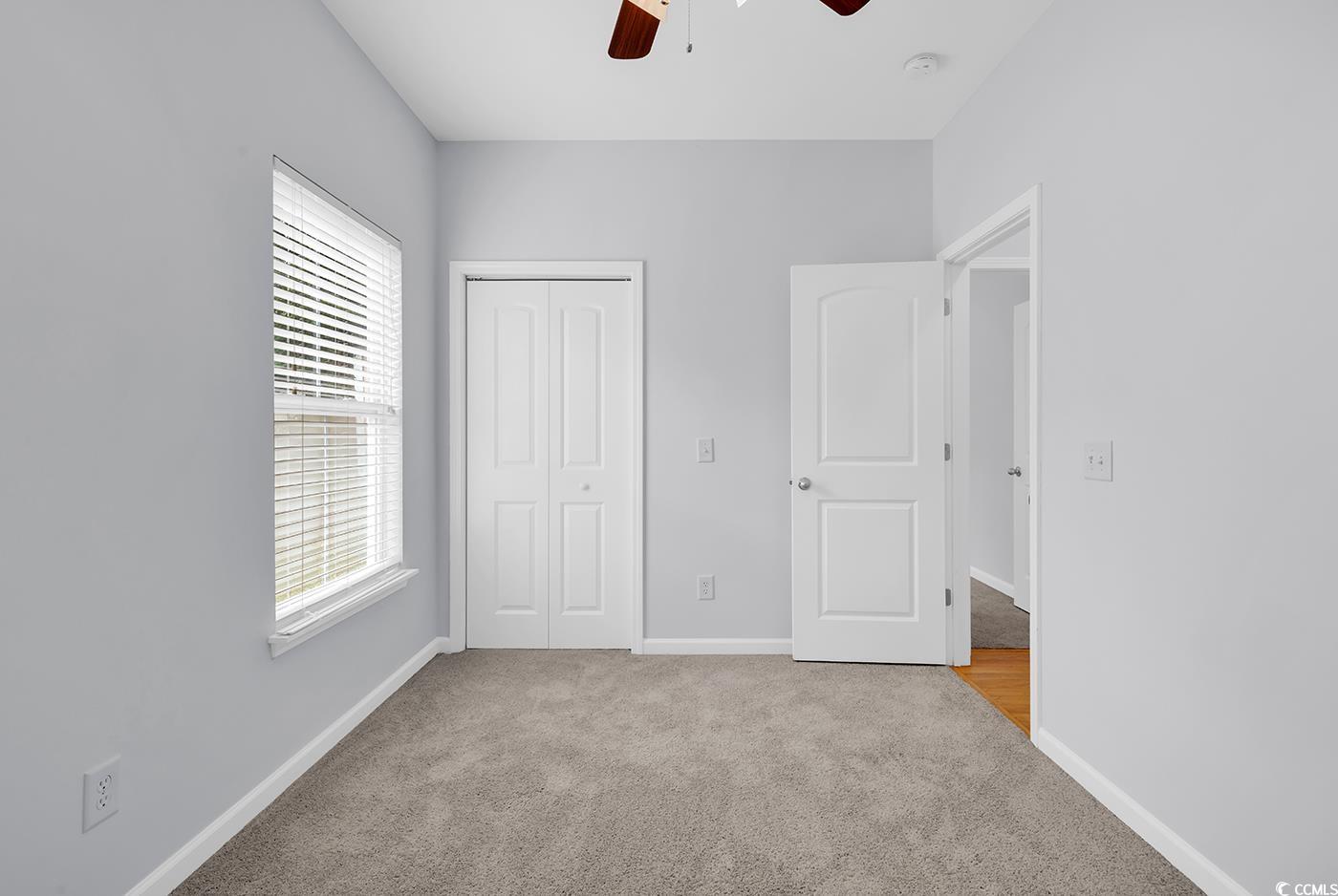 1636 Stuart Square Circle Myrtle Beach, SC 29577 - Photo 21 of 28 Unfurnished bedroom with carpet floors, a closet, and a ceiling fan