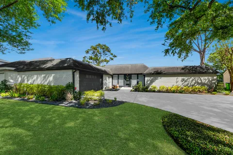 a front view of a house with a garden and sitting area