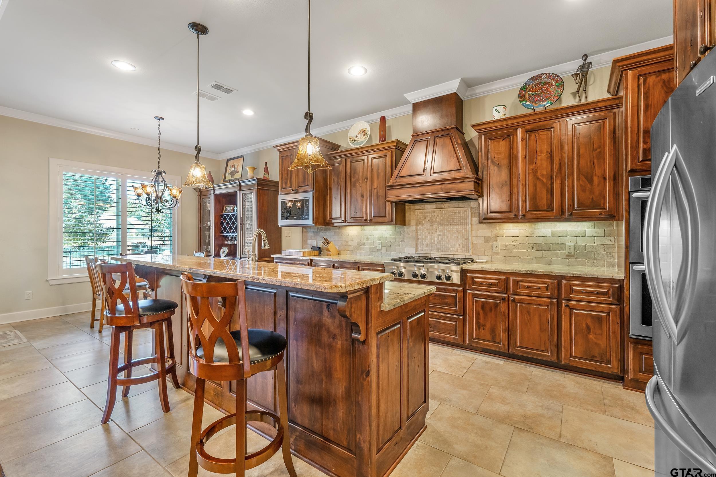 7311 Cross Road Tyler, TX 75703 - Photo 11 of 36 a kitchen with stainless steel appliances granite countertop a sink a stove and a refrigerator