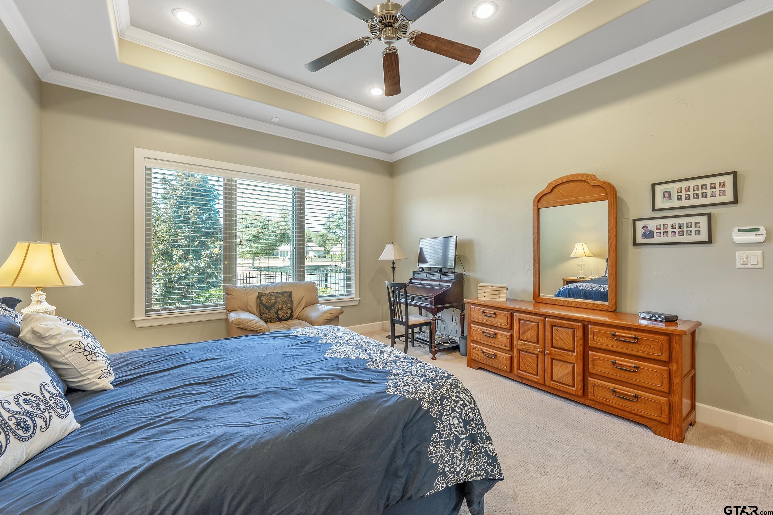 7311 Cross Road Tyler, TX 75703 - Photo 19 of 36 a bed room with a bed and a chandelier