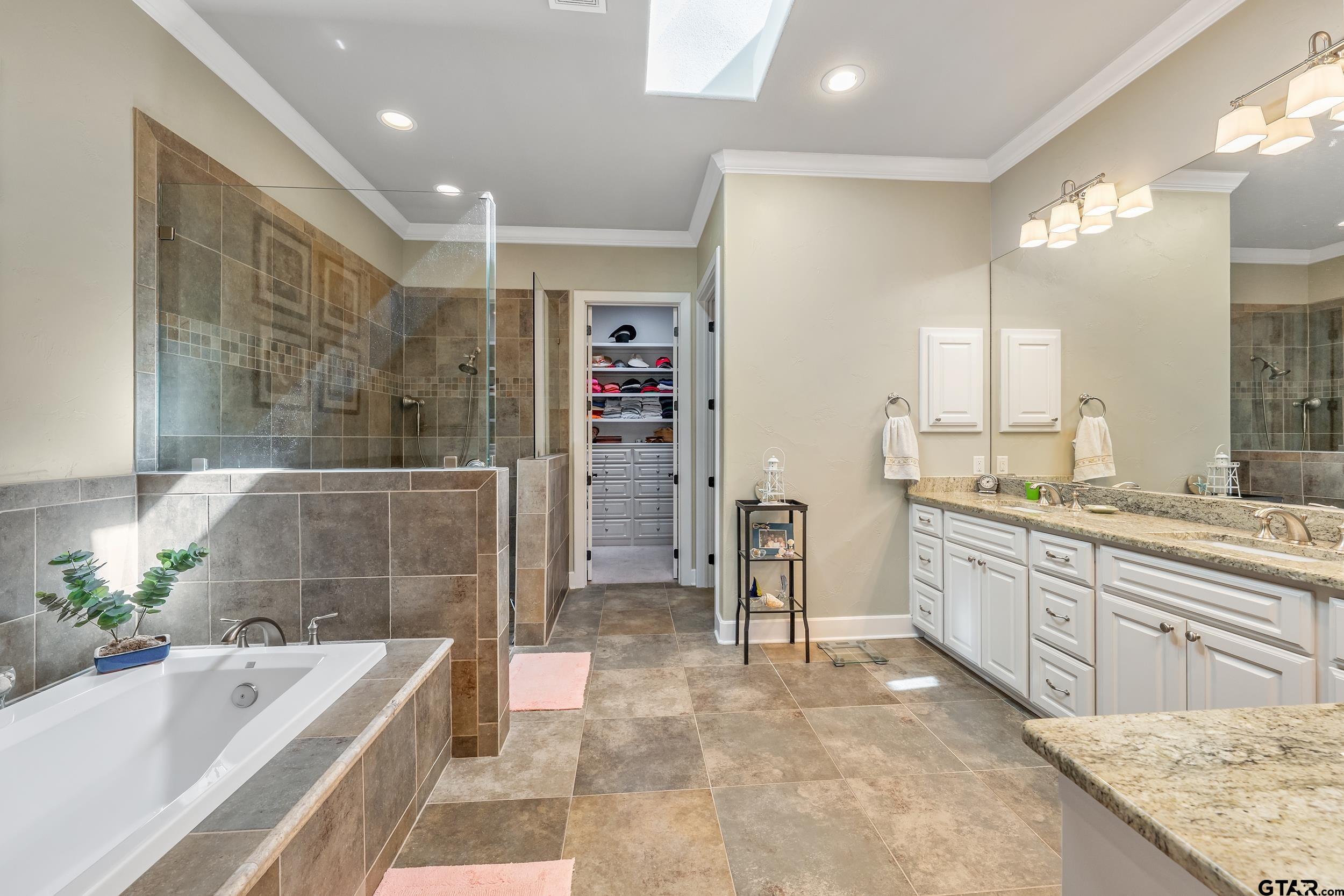 7311 Cross Road Tyler, TX 75703 - Photo 20 of 36 a spacious bathroom with a granite countertop tub sink and mirror