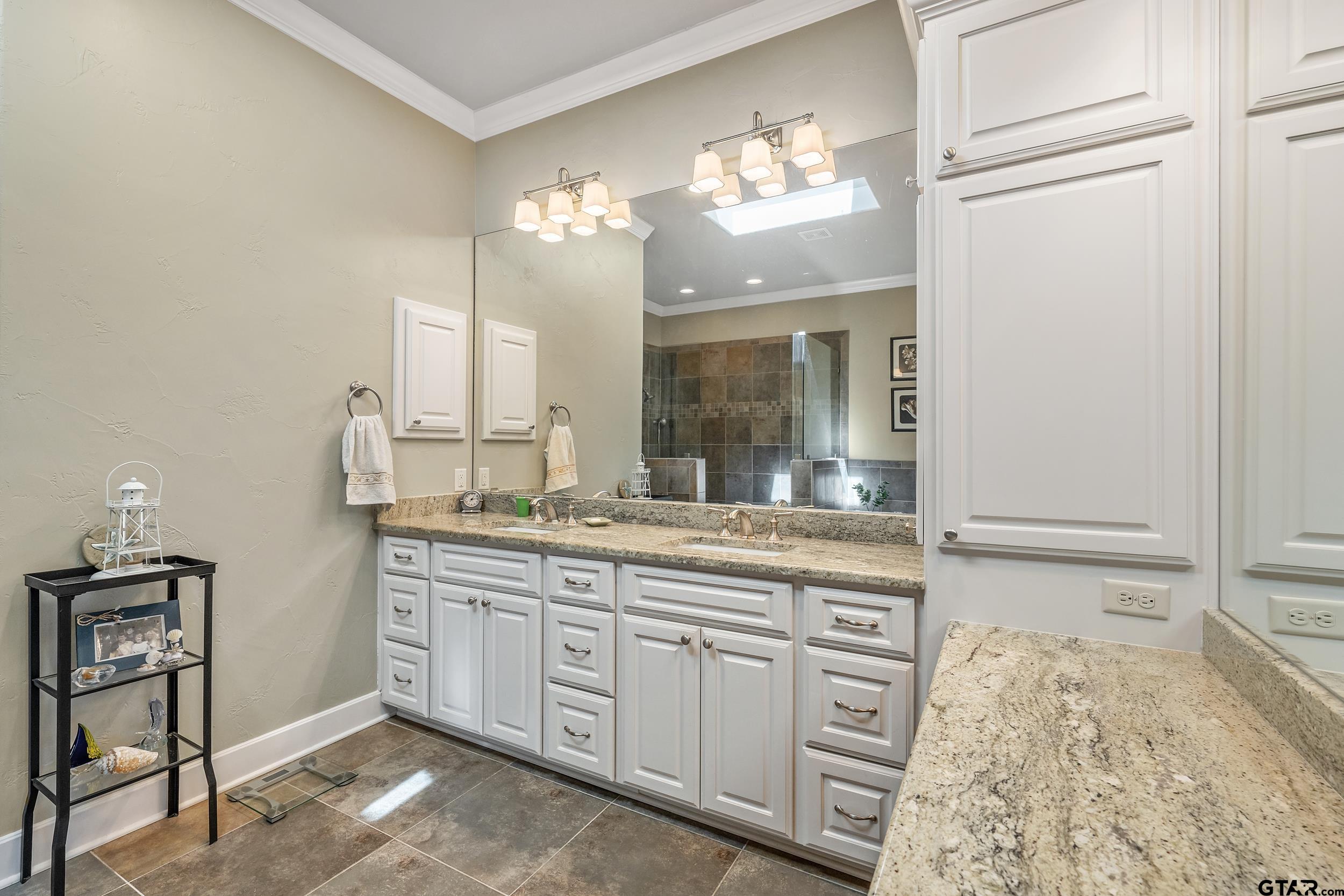 7311 Cross Road Tyler, TX 75703 - Photo 21 of 36 a bathroom with a double vanity sink and a mirror