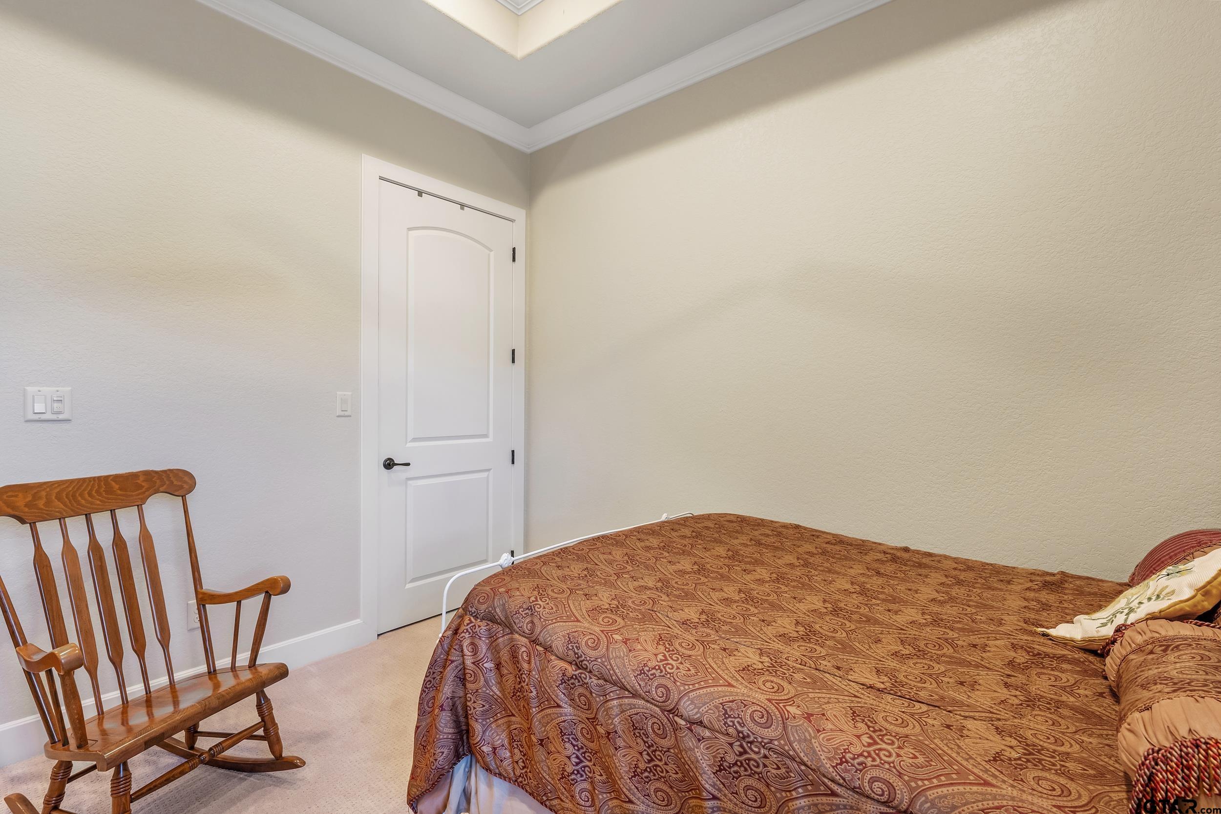 7311 Cross Road Tyler, TX 75703 - Photo 24 of 36 a bedroom with a bed and chair