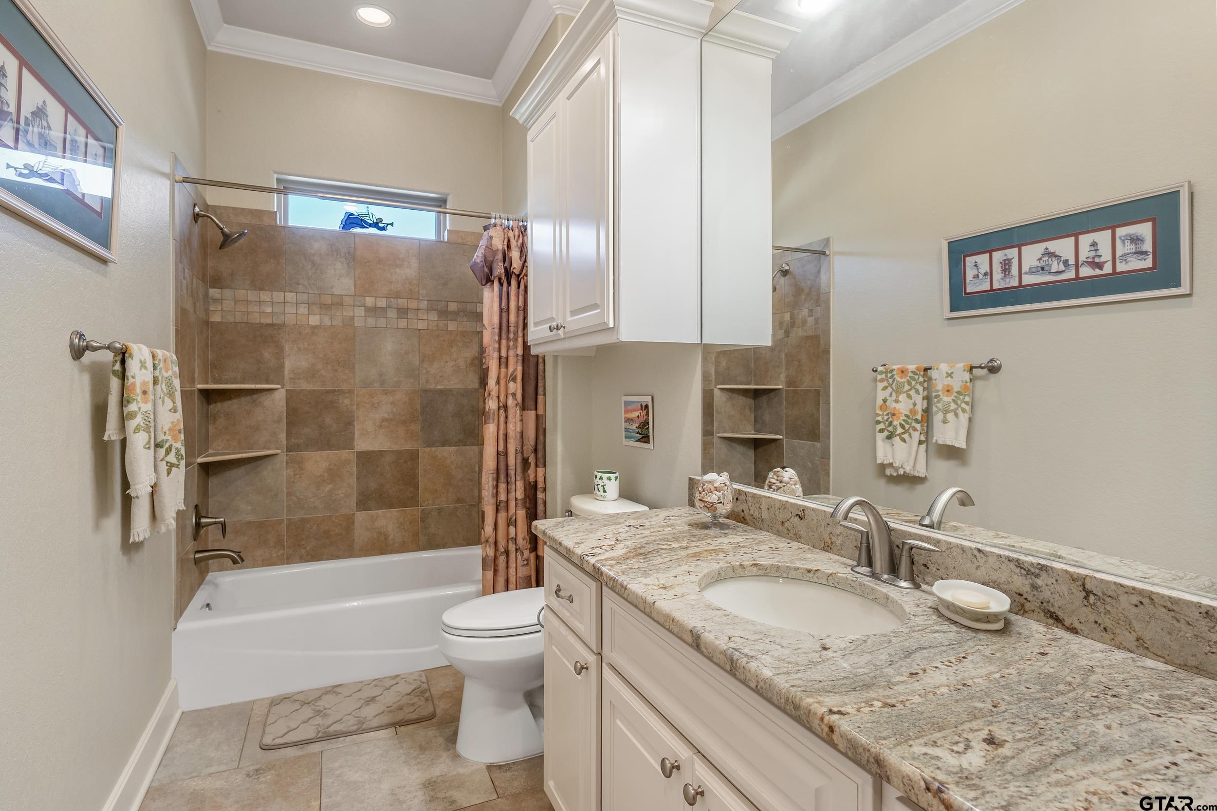 7311 Cross Road Tyler, TX 75703 - Photo 25 of 36 a bathroom with a granite countertop sink toilet and shower
