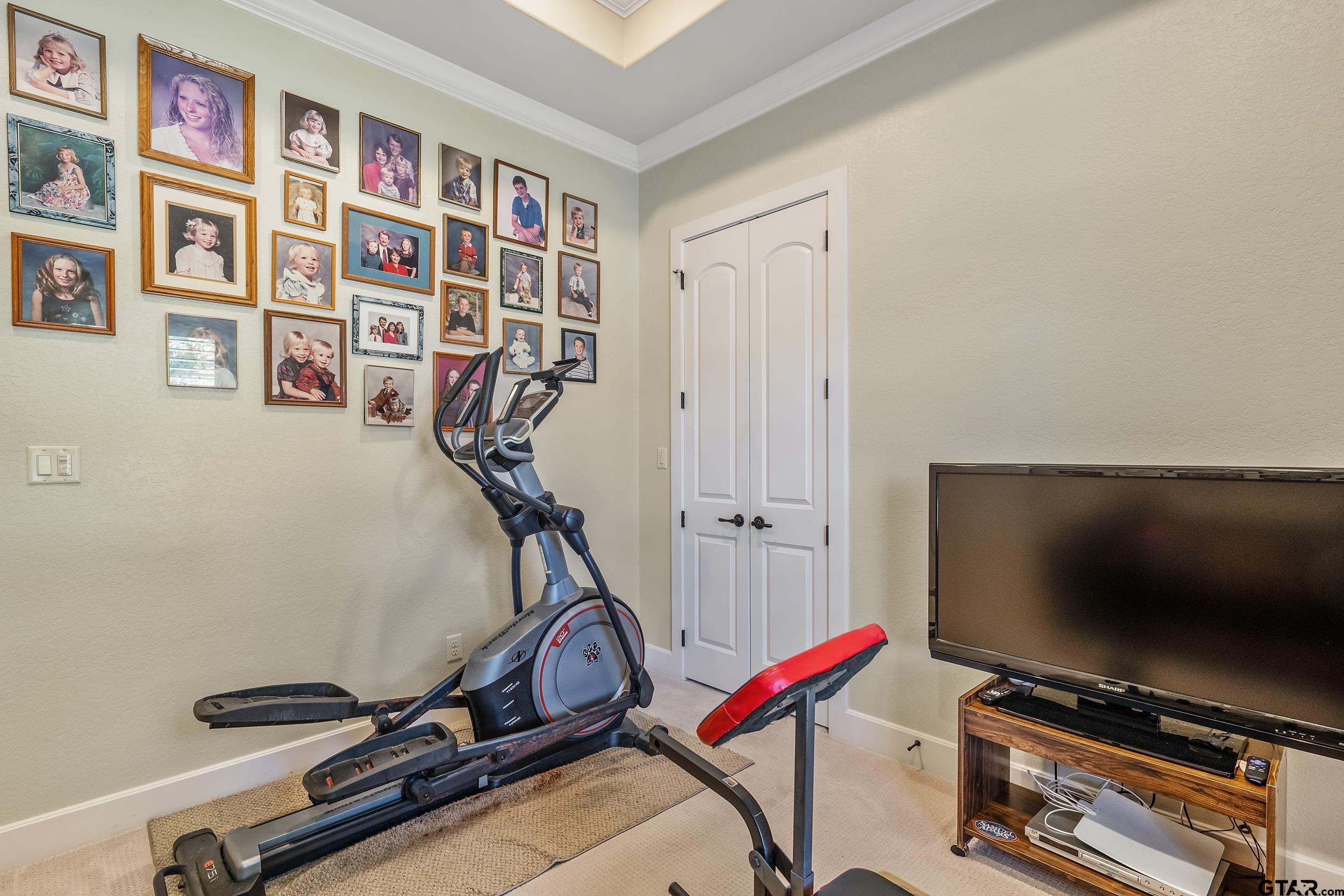7311 Cross Road Tyler, TX 75703 - Photo 29 of 36 a room with gym equipment and a flat screen tv