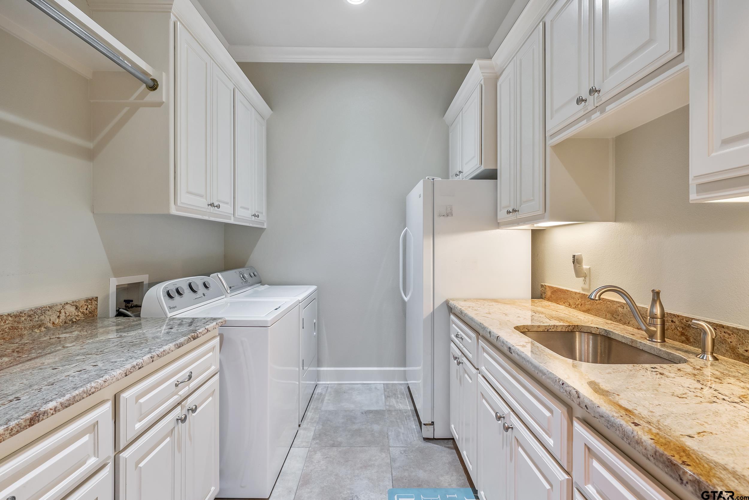 7311 Cross Road Tyler, TX 75703 - Photo 30 of 36 a kitchen with a sink a stove and refrigerator