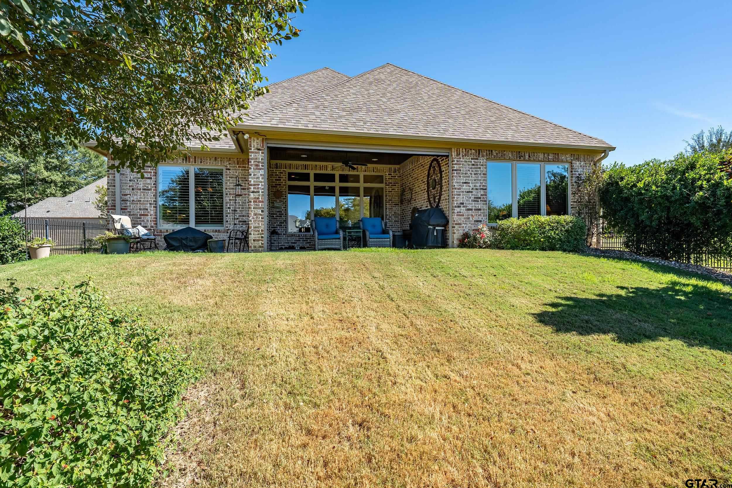 7311 Cross Road Tyler, TX 75703 - Photo 34 of 36 a view of a house with swimming pool and a yard